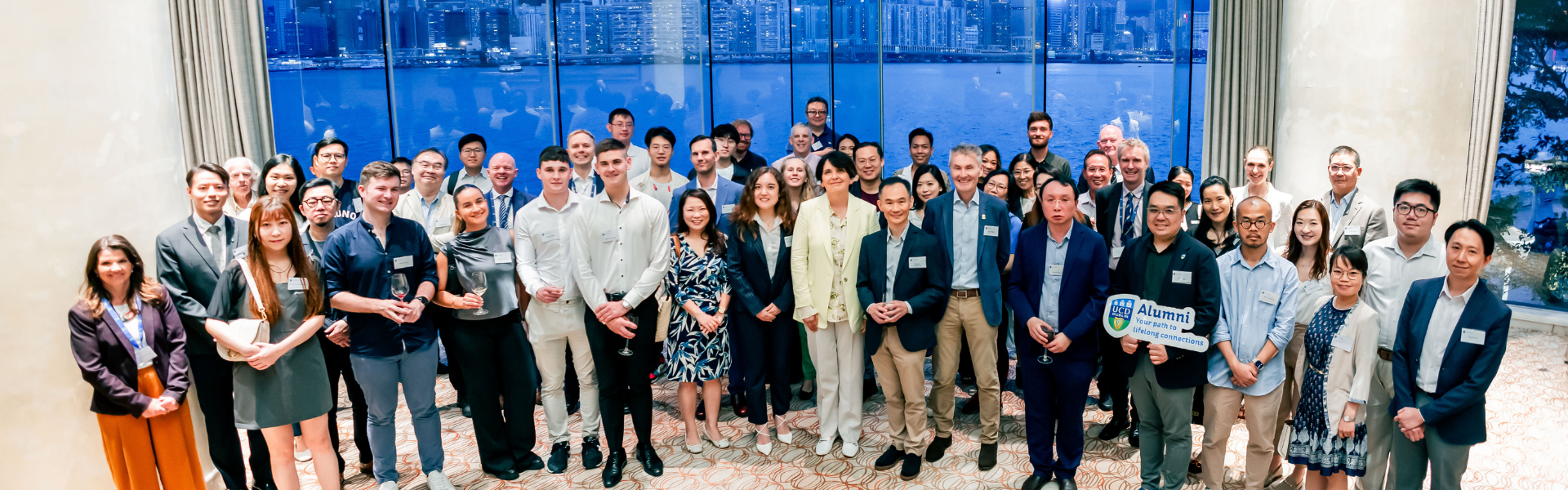 A group of alumni with Prof Orla Feely, President of UCD, at a global event.